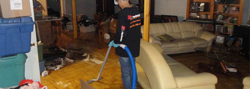 Toronto water damage restoration team extracting water and drying structure